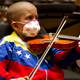 Sthefany Serrano, 6, a member of the Alma Llanera Hospital Care Program's orchestra for sick children, performs during their first anniversary concert in Caracas June 29, 2013. The program is one of the most recent initiatives of Venezuela's musical education program known as El Sistema, whose most famous alumnus is Gustavo Dudamel. The program teaches hospital-bound children to play musical instruments during their treatment. Picture taken June 29, 2013. REUTERS/Carlos Garcia Rawlins